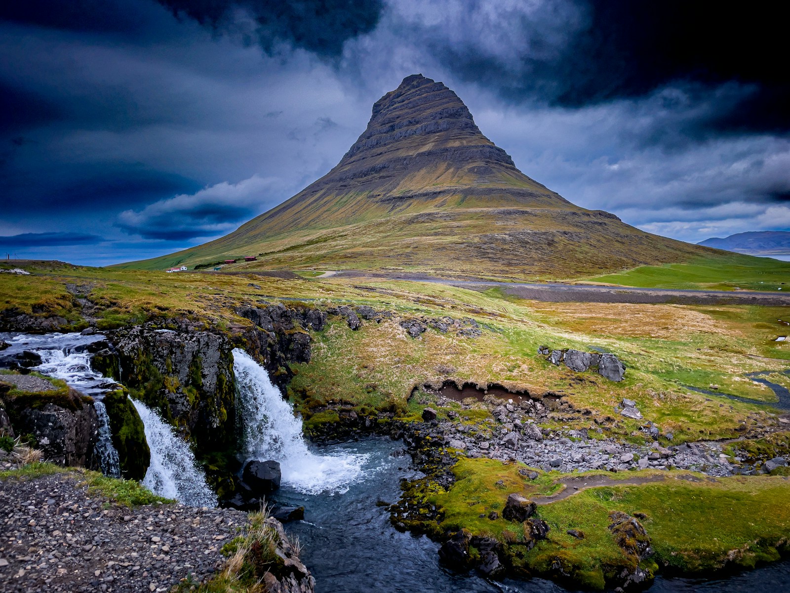 a mountain with a waterfall in the middle of it